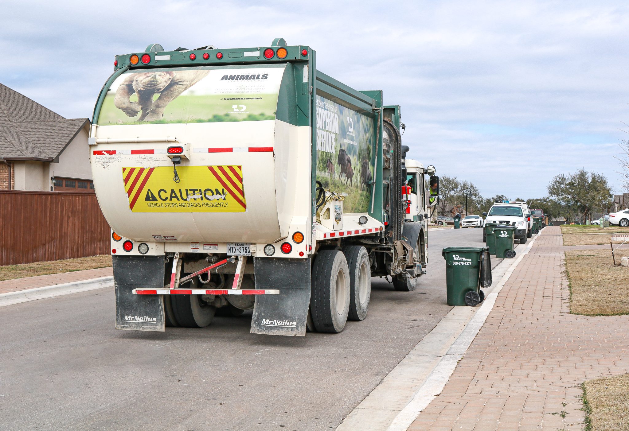 TDS garbage truck picking up curbside trash
